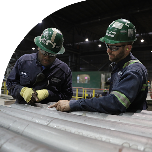 two workers in factory in hard hats